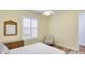 Bright bedroom featuring plantation shutters, ceiling fan, and wood-look flooring at 7081 Grassland Ct, Sarasota, FL 34241