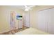 Bedroom with wood floors, double closets, and a tv at 7081 Grassland Ct, Sarasota, FL 34241
