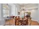 Elegant dining area showcasing a wooden table with seating for six, complemented by hardwood floors and stylish decor at 7081 Grassland Ct, Sarasota, FL 34241