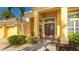 Inviting front entrance with double doors, manicured landscaping, and a covered porch at 7081 Grassland Ct, Sarasota, FL 34241