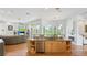 Kitchen island with a granite countertop, stainless steel appliances, custom wood cabinets, and a breakfast bar at 7081 Grassland Ct, Sarasota, FL 34241