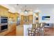 Well-equipped kitchen featuring custom wood cabinetry, modern appliances, granite countertops, and a breakfast bar at 7081 Grassland Ct, Sarasota, FL 34241