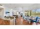 Open-concept kitchen with granite countertops, stainless steel appliances, and a breakfast bar overlooking the living area at 7081 Grassland Ct, Sarasota, FL 34241
