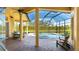 Enclosed lanai with covered seating, a pool, and a view of the water at 7081 Grassland Ct, Sarasota, FL 34241