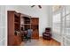 Home office with wood floors, built-in shelves, and a comfortable leather chair at 7081 Grassland Ct, Sarasota, FL 34241