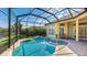 Inviting screened-in pool with an attached spa and seating area at 7081 Grassland Ct, Sarasota, FL 34241