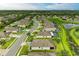 An aerial view showcases a community with a winding pond and manicured lawns at 7410 61 E St, Palmetto, FL 34221