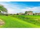 A lush backyard features a serene pond view and rod iron fencing at 7410 61 E St, Palmetto, FL 34221