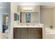 Bright bathroom features a double sink vanity, large mirror, and a soaking tub at 7410 61 E St, Palmetto, FL 34221