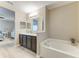 Beautiful bathroom with double vanity, soaking tub, and wood-look vinyl flooring at 7410 61 E St, Palmetto, FL 34221