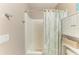 Bright bathroom showcasing a bathtub with a decorative shower curtain and built-in shelving at 7410 61 E St, Palmetto, FL 34221
