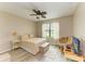 Cozy bedroom with a full size bed, ceiling fan, natural light, and neutral tones at 7410 61 E St, Palmetto, FL 34221