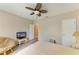 Bedroom featuring a full size bed, fan, and seating area; bathed in neutral tones at 7410 61 E St, Palmetto, FL 34221