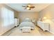 Cozy bedroom features a ceiling fan, wood-look floors, and white furnishings at 7410 61 E St, Palmetto, FL 34221