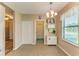Dining area features pendant lighting, tile floors, and access to the front entryway at 7410 61 E St, Palmetto, FL 34221