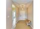 Inviting entryway with neutral paint, pendant lighting, and a charming bench with storage basket at 7410 61 E St, Palmetto, FL 34221