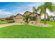 Charming one-story home with a well-maintained lawn and tropical landscaping, including palm trees at 7410 61 E St, Palmetto, FL 34221