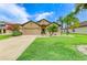 Charming one-story home boasts a well-manicured lawn, mature landscaping, and attached two-car garage at 7410 61 E St, Palmetto, FL 34221
