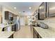 Spacious kitchen featuring dark wood cabinetry, stainless steel appliances, and granite countertops at 7410 61 E St, Palmetto, FL 34221