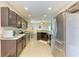 Open kitchen features stainless steel appliances and dark cabinetry with tile flooring at 7410 61 E St, Palmetto, FL 34221