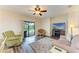 A living room featuring sliders to the lanai and pool with a ceiling fan and TV at 7410 61 E St, Palmetto, FL 34221