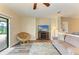 Living room with a ceiling fan, TV, and sliders to the lanai and pool area at 7410 61 E St, Palmetto, FL 34221