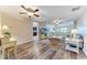 Open-concept living room with ceiling fans, hardwood floors, and plenty of natural light at 7410 61 E St, Palmetto, FL 34221