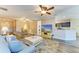 Bright living room featuring modern decor, ceiling fans, and a seamless open floor plan at 7410 61 E St, Palmetto, FL 34221