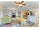A living space featuring a ceiling fan, dining area, and view into the kitchen area at 7410 61 E St, Palmetto, FL 34221