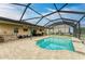 Screened-in pool with tanning ledge and bar area for entertaining guests at 7410 61 E St, Palmetto, FL 34221