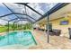 Relaxing screened-in pool area with a brick paved patio, outdoor furniture, and lush greenery at 7410 61 E St, Palmetto, FL 34221