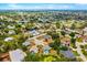 Wide aerial view showcasing a diverse neighborhood with lush greenery and charming streets near a water tower at 7615 17Th W Ave, Bradenton, FL 34209