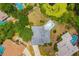 A straight down aerial view highlights in-ground pool, backyard pond, established tree coverage and neighborhood layout at 7615 17Th W Ave, Bradenton, FL 34209