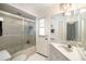 Bathroom showcasing a glass shower, toilet, and sink with cabinets at 7615 17Th W Ave, Bradenton, FL 34209