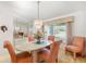 Bright dining room with an oval table, upholstered chairs, and a mirrored accent wall at 7615 17Th W Ave, Bradenton, FL 34209