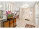 Elegant foyer featuring tile flooring and an ornate console table with a vibrant floral arrangement at 7615 17Th W Ave, Bradenton, FL 34209