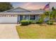 Charming single-story home featuring a well-maintained front yard, driveway, and attached garage at 7615 17Th W Ave, Bradenton, FL 34209