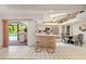 Open kitchen with bar seating, stainless steel appliances, and a dining area with an indoor/outdoor feel at 7615 17Th W Ave, Bradenton, FL 34209