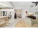 Bright living room featuring tile floors, a bar-top counter, and a view of the entryway at 7615 17Th W Ave, Bradenton, FL 34209