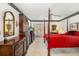 Spacious main bedroom featuring a four-poster bed and a dark wood dresser at 7615 17Th W Ave, Bradenton, FL 34209