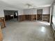 Spacious living room featuring exposed wall studs, concrete flooring, and natural light from windows, ready for renovation at 782 Birdsong Ln, Sarasota, FL 34242