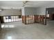 Open-concept living area with exposed studs, concrete flooring, and natural light, awaiting complete renovation at 782 Birdsong Ln, Sarasota, FL 34242