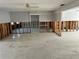 Bright living room with concrete floors, exposed studs, and partial wall construction, ideal for renovation projects at 782 Birdsong Ln, Sarasota, FL 34242