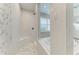 Close-up of a frameless glass shower and soaking tub with mosaic tile accents and white fixtures at 8264 Summer Night Rd, Sarasota, FL 34241