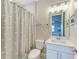 A charming bathroom features a whale patterned shower curtain, modern vanity, and a framed whale art print at 8264 Summer Night Rd, Sarasota, FL 34241