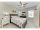 A bedroom featuring nautical themed bedding, a ceiling fan, and a window with plantation shutters at 8264 Summer Night Rd, Sarasota, FL 34241