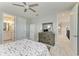 A bedroom with nautical themed decor features a wooden dresser and an open doorway to the en-suite bathroom at 8264 Summer Night Rd, Sarasota, FL 34241