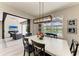 Dining area featuring views to the outdoor living, table for six, and sliding glass doors leading to the patio at 8264 Summer Night Rd, Sarasota, FL 34241