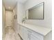 Hallway with white cabinets, granite countertops, a mirror and decorative touches enhance the entrance at 8264 Summer Night Rd, Sarasota, FL 34241