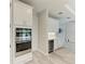 Modern kitchen details include built-in stainless ovens, wine cooler, and crisp white cabinets with sleek hardware at 8264 Summer Night Rd, Sarasota, FL 34241